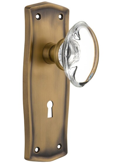 Prairie Plate with Oval Clear Crystal Knob with Keyhole in Antique Brass.